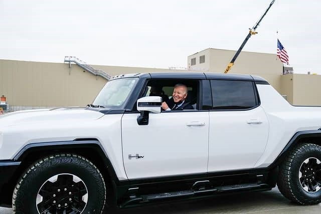 President Joe Biden drives a Hummer EV during a trip to the General Motors electric vehicle assembly plant in Detroit, Michigan, November 17, 2021.