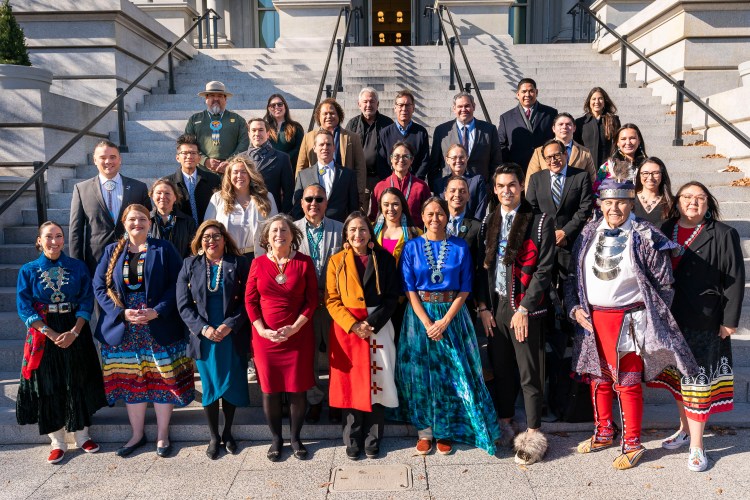 Interior Secretary Deb Haaland takes a photo with White House Native American staffers on the Navy Steps of the Eisenhower Executive Office Building at the White House