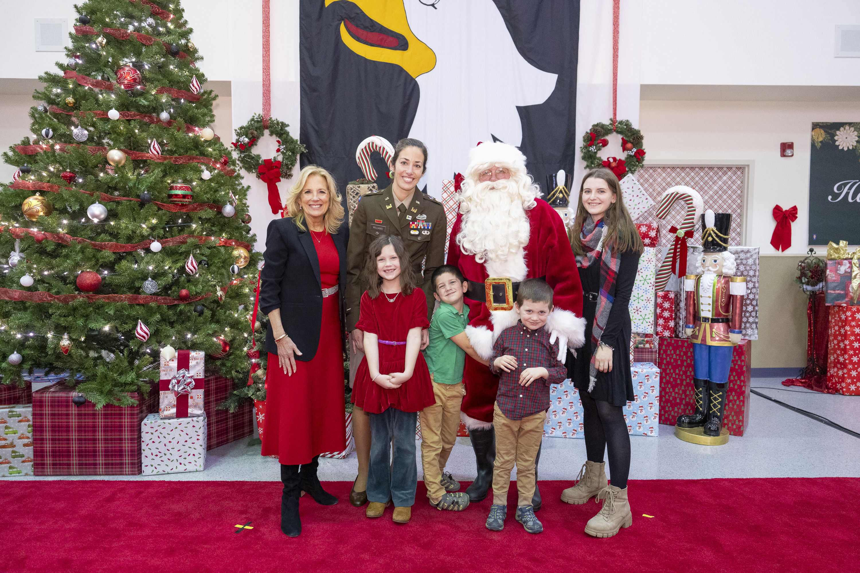 First Lady Jill Biden and Santa Claus participate in a photo line with military families for a holiday party at Fort Campbell, Kentucky on Saturday, December 23, 2023.