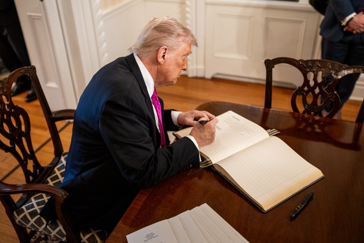 President Donald Trump signs the guest book at the superintendent quarters at West Point Military Academy, Saturday, May 24, 2025, in West Point, New York. (Official White House Photo by Daniel Torok)