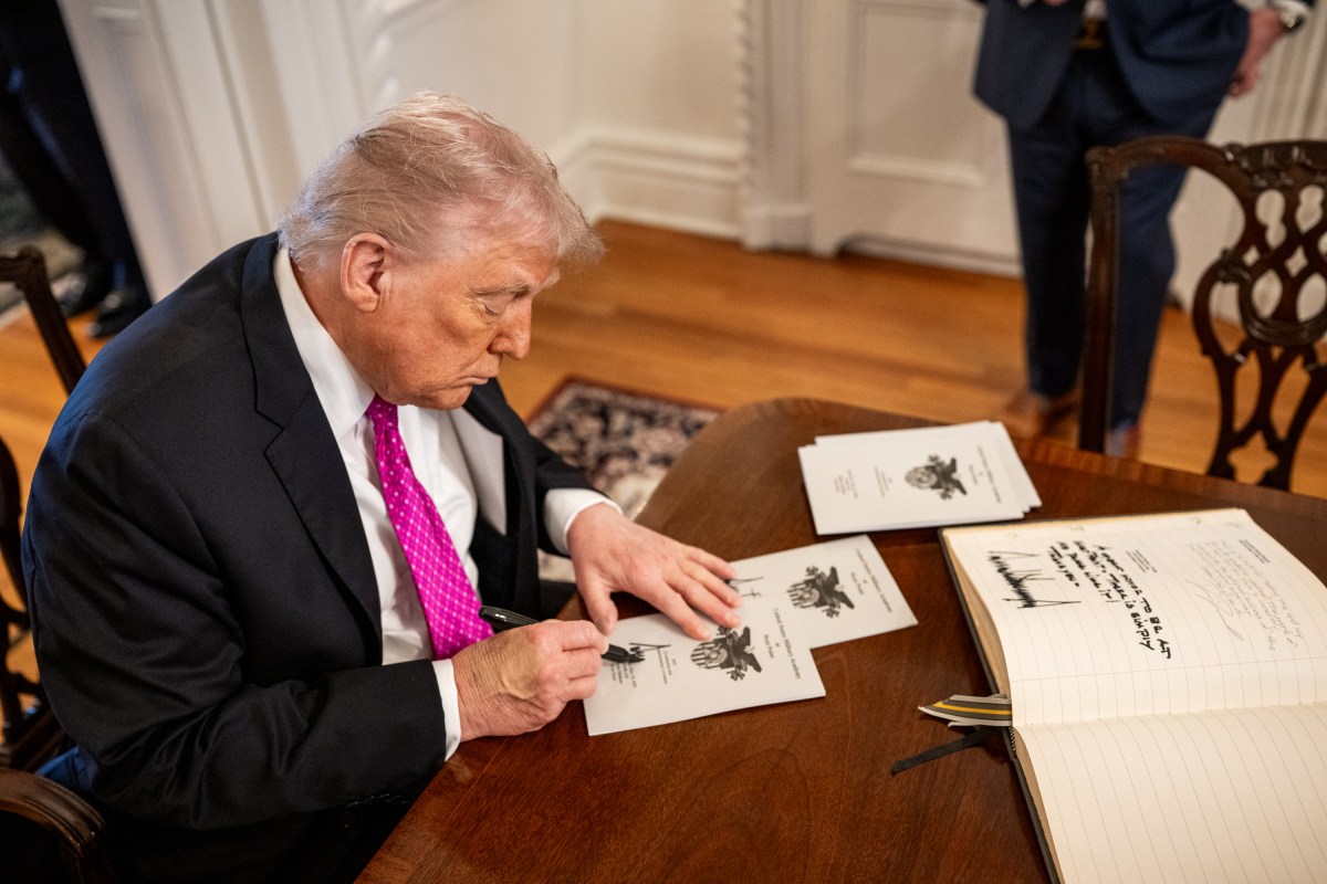 President Donald Trump signs the guest book at the superintendent quarters at West Point Military Academy, Saturday, May 24, 2025, in West Point, New York. (Official White House Photo by Daniel Torok)