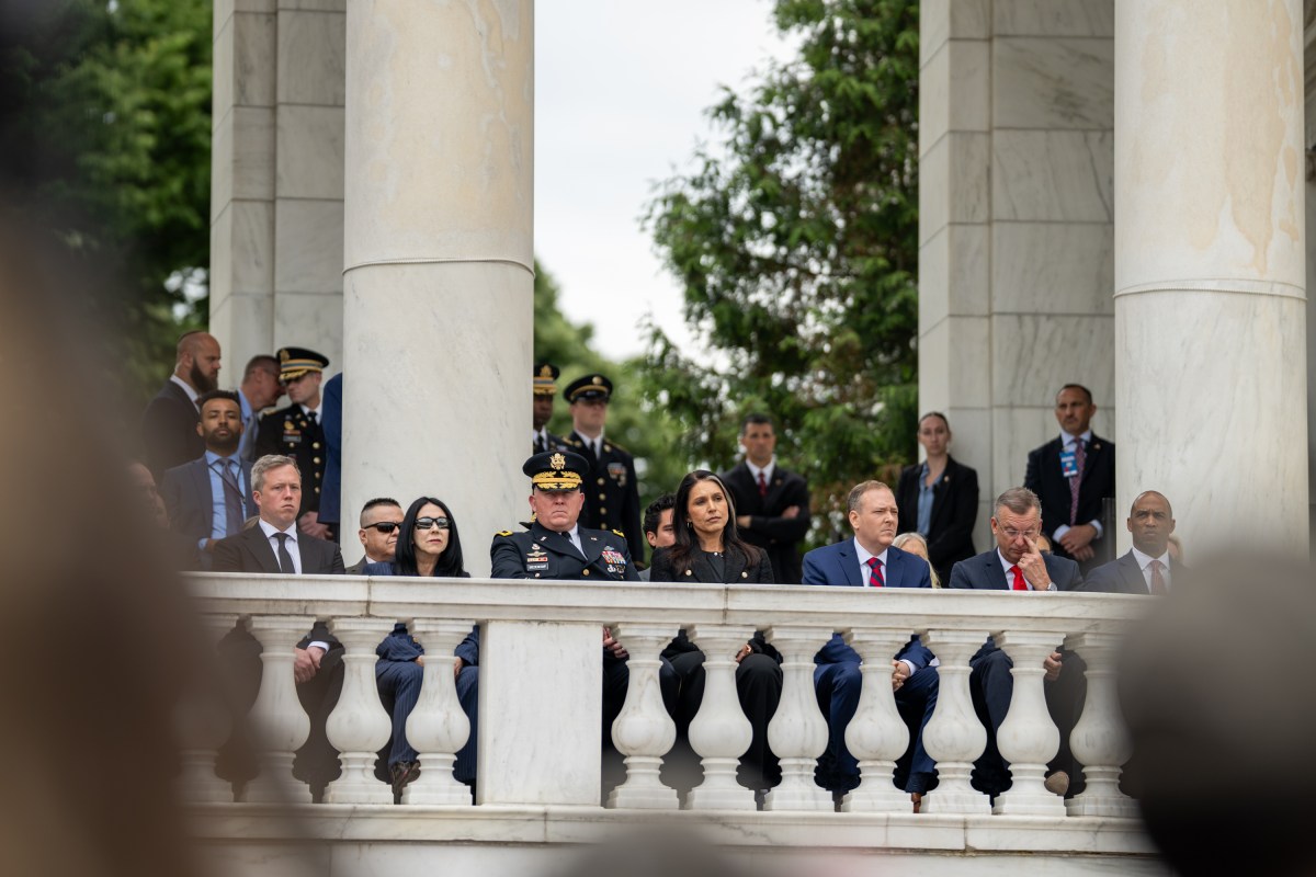 Director of National Intelligence Tulsi Gabbard listens to President Donald Trump give remarks during a Memorial Day ceremony at Arlington National Cemetery Amphitheater, Monday, May 26, 2025, in Arlington, Virginia. (Official White House Photo by Daniel Torok)