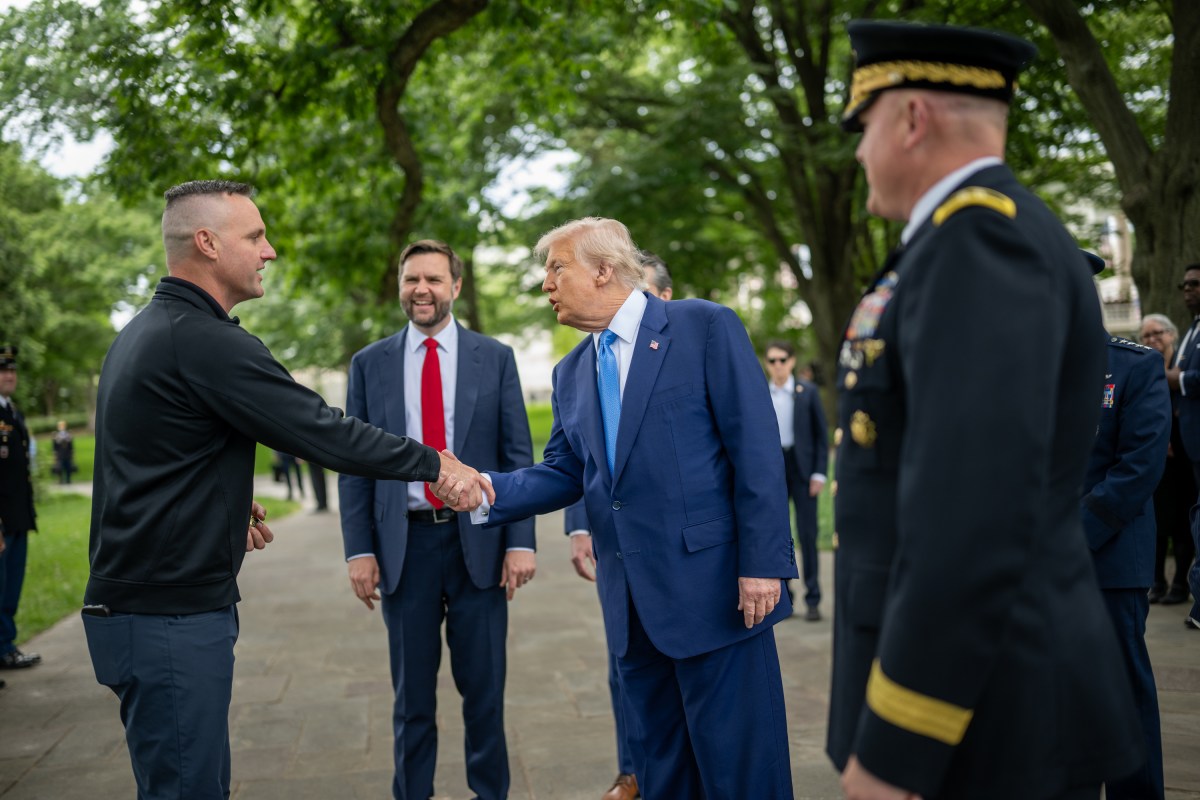 President Donald Trump speaks with members of the military before departing Arlington National Cemetery in Arlington, Virginia after participating in Memorial Day ceremonies, Monday, May 26, 2025. (Official White House Photo by Daniel Torok)