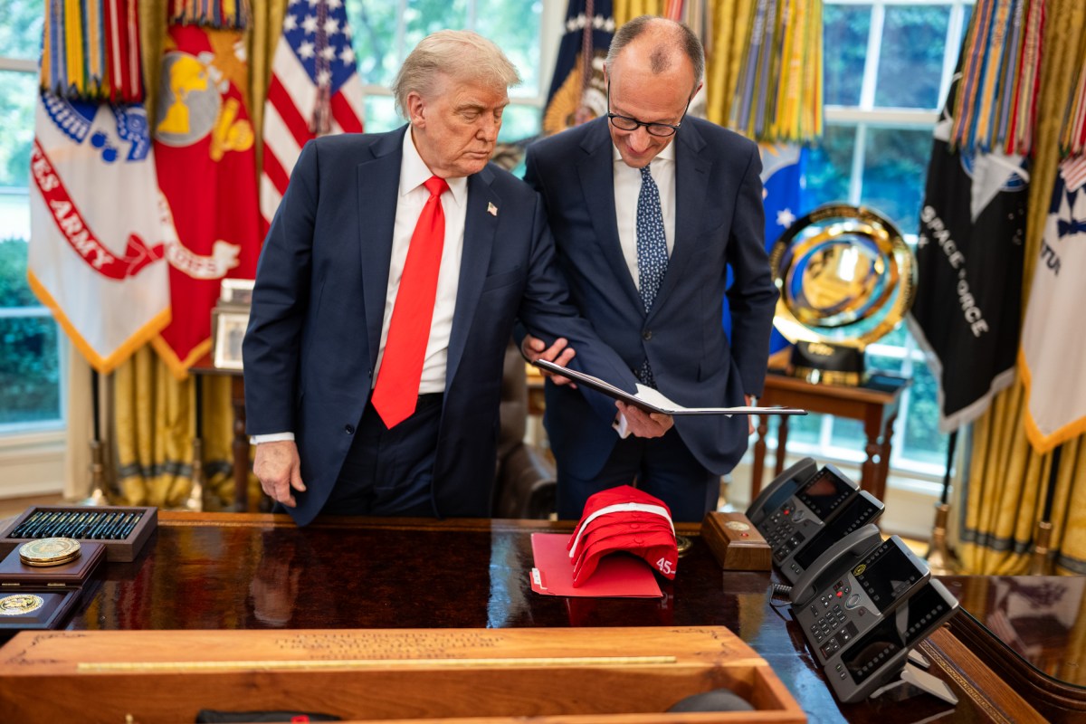 President Donald Trump exchanges gifts with German Chancellor Friedrich Merz, Thursday, June 5, 2025, in the Oval Office. (Official White House Photo by Daniel Torok)