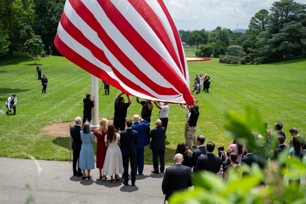 President Donald Trump watches as the American flag is raised on the newly-installed flagpole on the South Lawn of the White House, Wednesday, June 18, 2025. (Official White House Photo by Molly Riley)