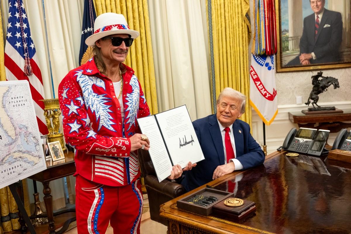 President Donald Trump signs an Executive Order alongside Kid Rock in the Oval Office, Monday, March 31, 2025. (Official White House Photo by Molly Riley)