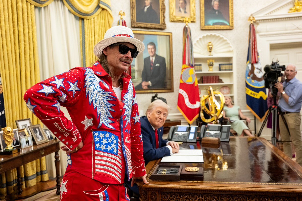 President Donald Trump signs an Executive Order alongside Kid Rock in the Oval Office, Monday, March 31, 2025. (Official White House Photo by Molly Riley)