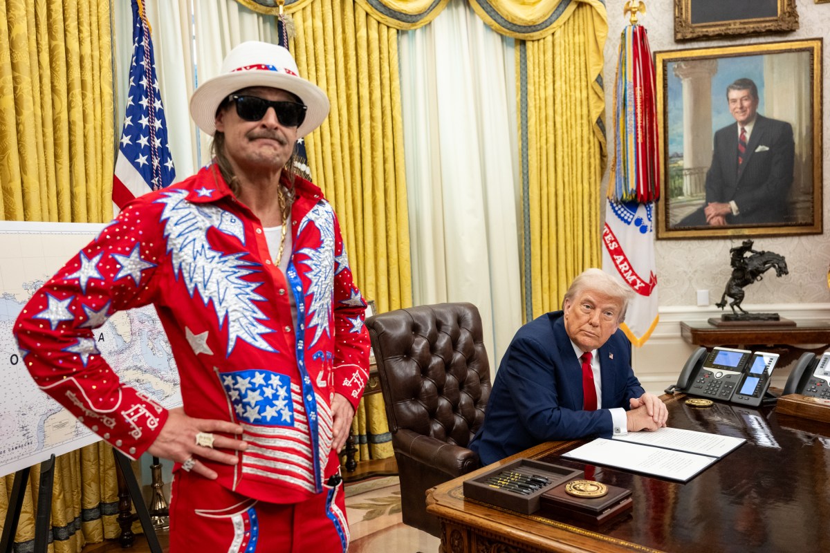 President Donald Trump signs an Executive Order alongside Kid Rock in the Oval Office, Monday, March 31, 2025. (Official White House Photo by Molly Riley)