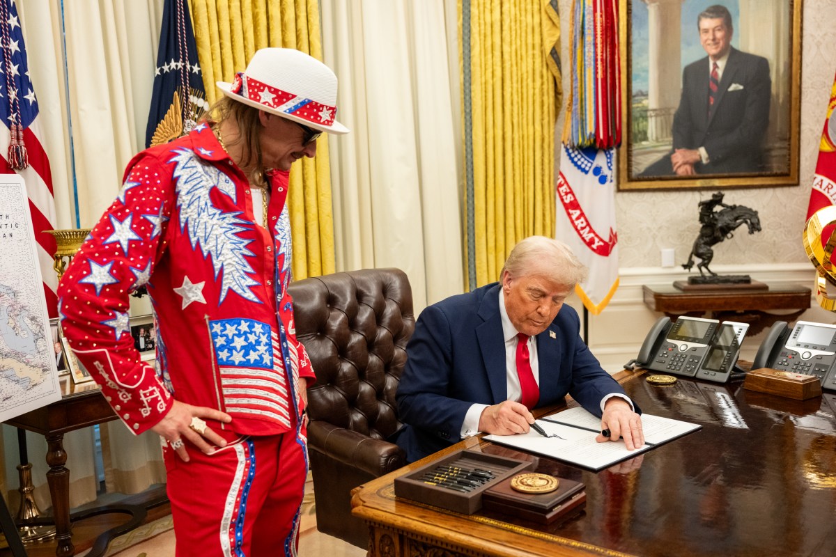 President Donald Trump signs an Executive Order alongside Kid Rock in the Oval Office, Monday, March 31, 2025. (Official White House Photo by Molly Riley)