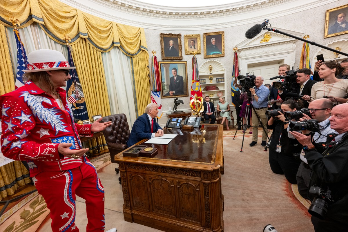 President Donald Trump signs an Executive Order alongside Kid Rock in the Oval Office, Monday, March 31, 2025. (Official White House Photo by Molly Riley)