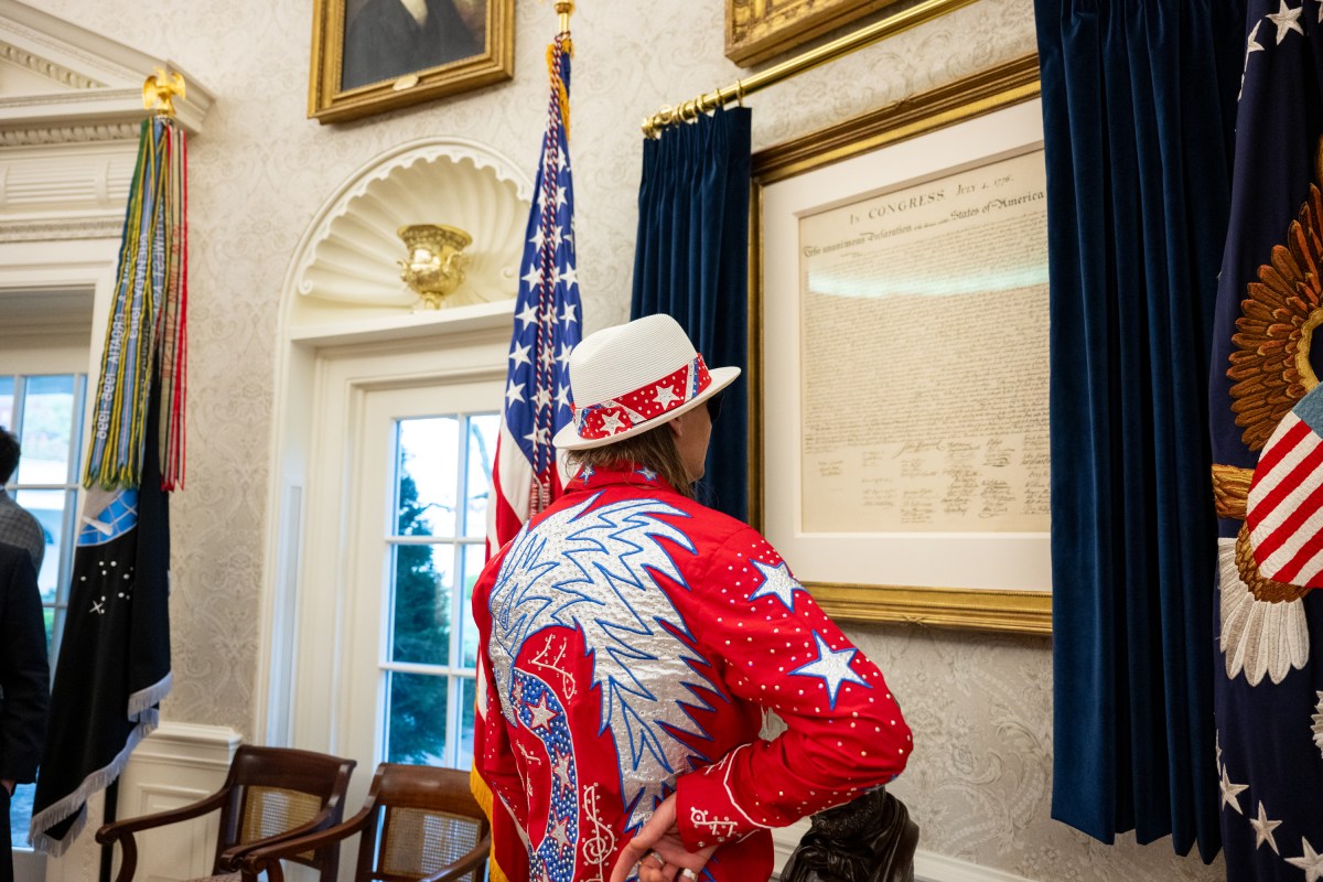 President Donald Trump signs an Executive Order alongside Kid Rock in the Oval Office, Monday, March 31, 2025. (Official White House Photo by Molly Riley)