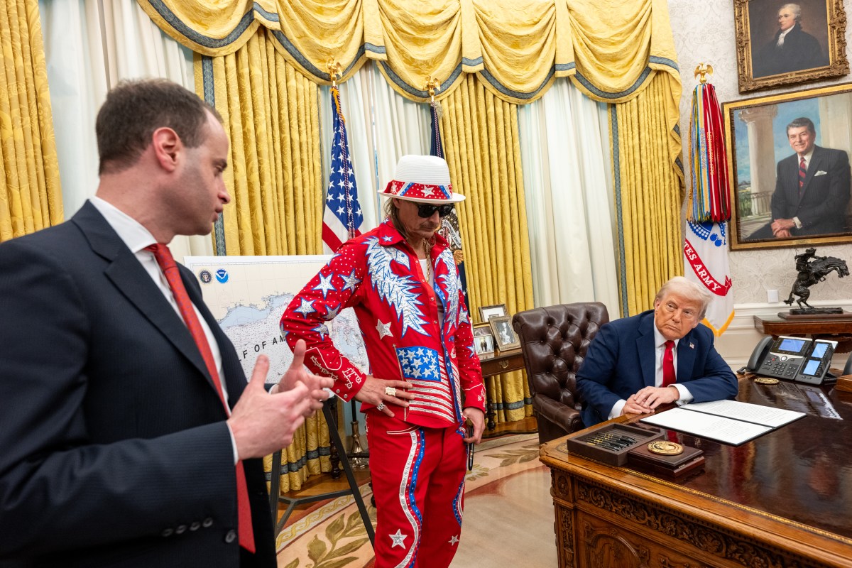 President Donald Trump signs an Executive Order alongside Kid Rock in the Oval Office, Monday, March 31, 2025. (Official White House Photo by Molly Riley)