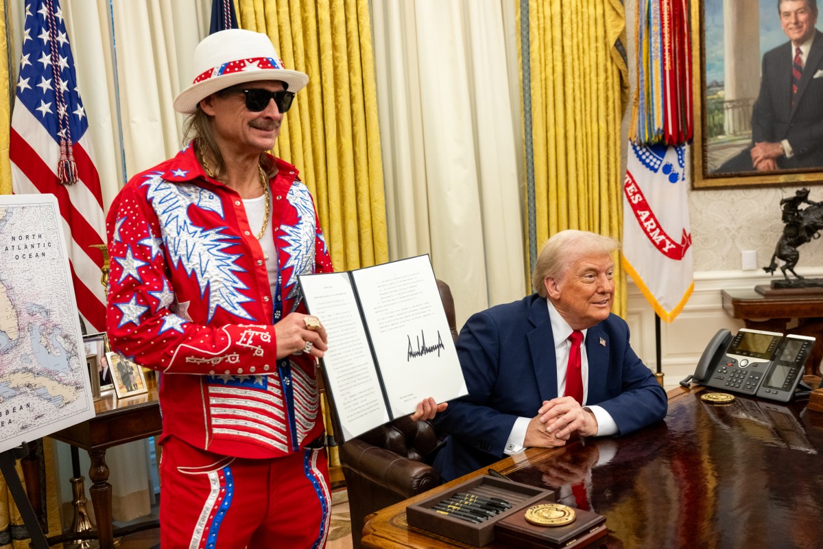 President Donald Trump signs an Executive Order alongside Kid Rock in the Oval Office, Monday, March 31, 2025. (Official White House Photo by Molly Riley)