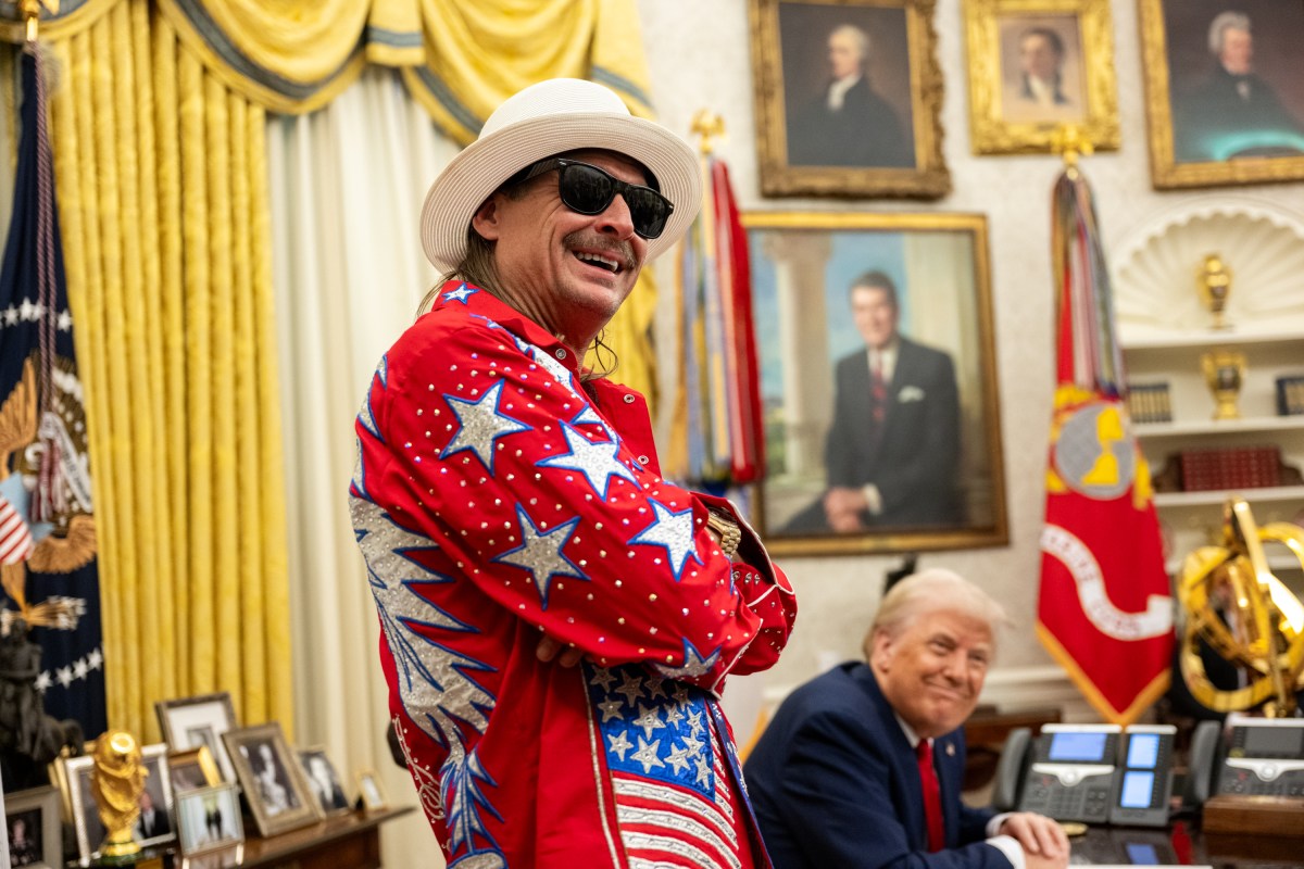 President Donald Trump signs an Executive Order alongside Kid Rock in the Oval Office, Monday, March 31, 2025. (Official White House Photo by Molly Riley)