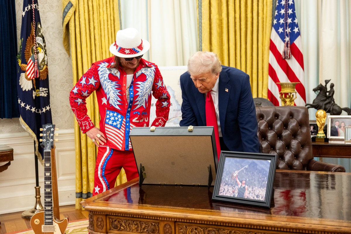 President Donald Trump signs an Executive Order alongside Kid Rock in the Oval Office, Monday, March 31, 2025. (Official White House Photo by Molly Riley)