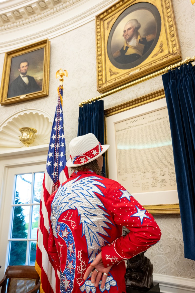 President Donald Trump signs an Executive Order alongside Kid Rock in the Oval Office, Monday, March 31, 2025. (Official White House Photo by Molly Riley)