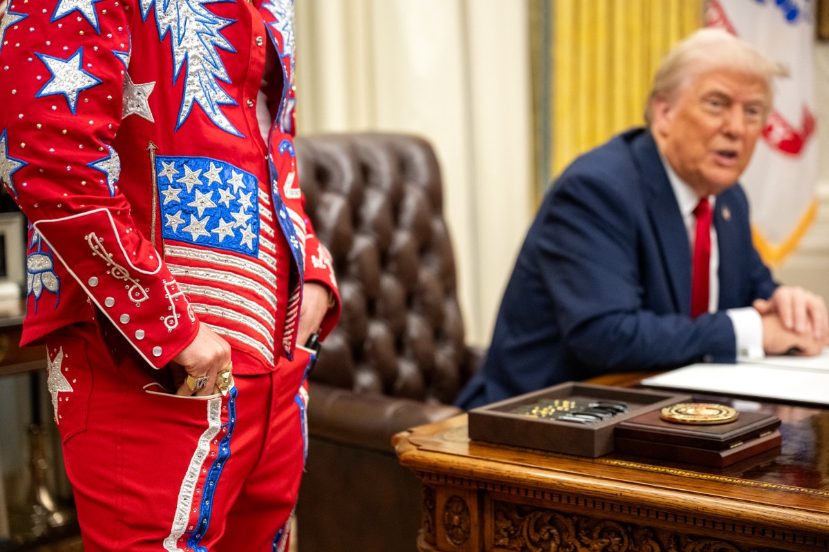 President Donald Trump signs an Executive Order alongside Kid Rock in the Oval Office, Monday, March 31, 2025. (Official White House Photo by Molly Riley)