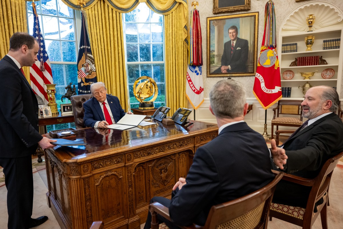 President Donald Trump signs an Executive Order alongside Kid Rock in the Oval Office, Monday, March 31, 2025. (Official White House Photo by Molly Riley)
