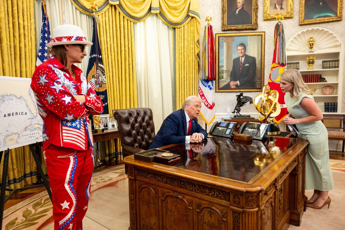 President Donald Trump signs an Executive Order alongside Kid Rock in the Oval Office, Monday, March 31, 2025. (Official White House Photo by Molly Riley)