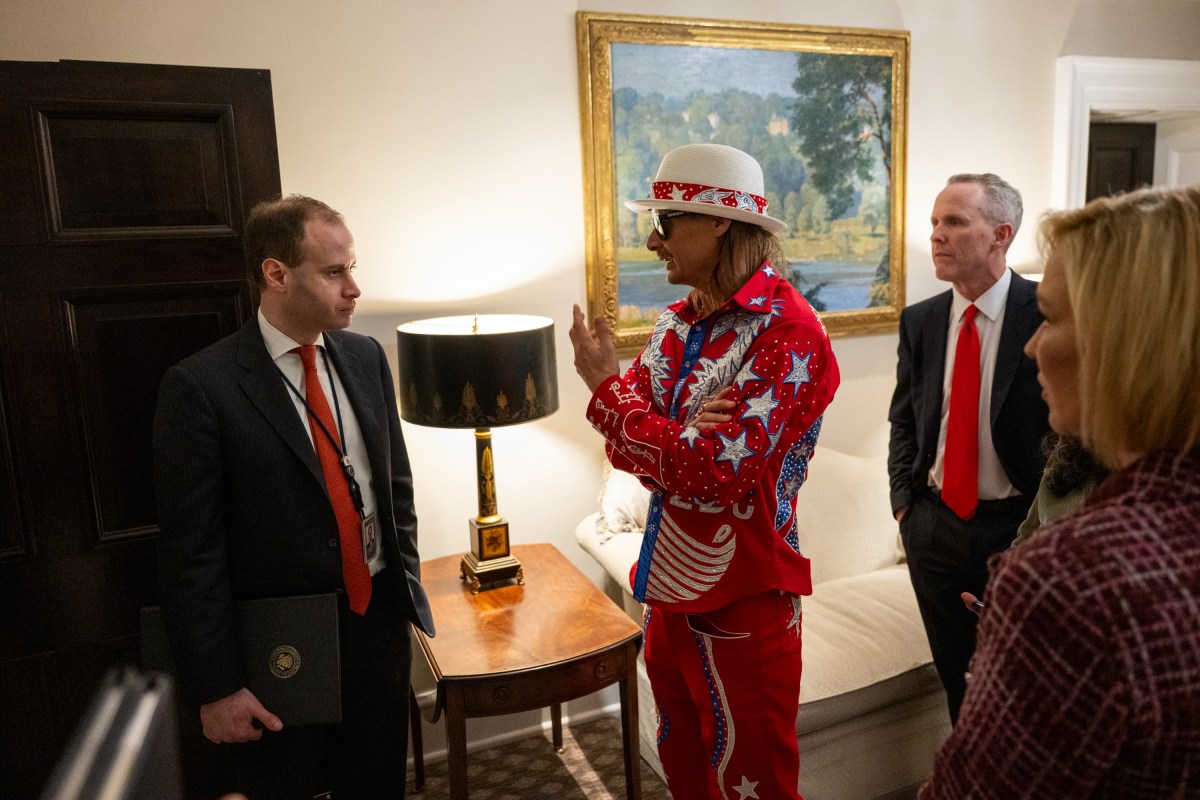 President Donald Trump signs an Executive Order alongside Kid Rock in the Oval Office, Monday, March 31, 2025. (Official White House Photo by Molly Riley)