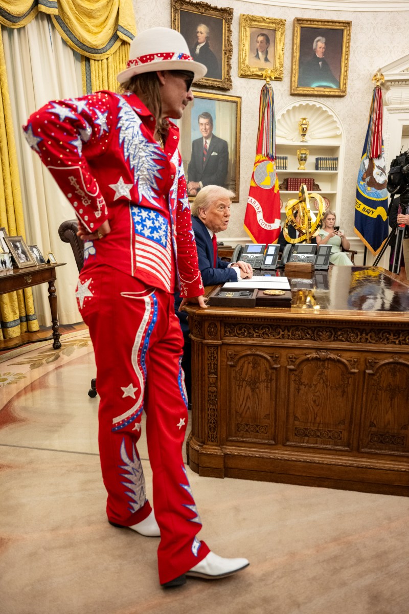 President Donald Trump signs an Executive Order alongside Kid Rock in the Oval Office, Monday, March 31, 2025. (Official White House Photo by Molly Riley)