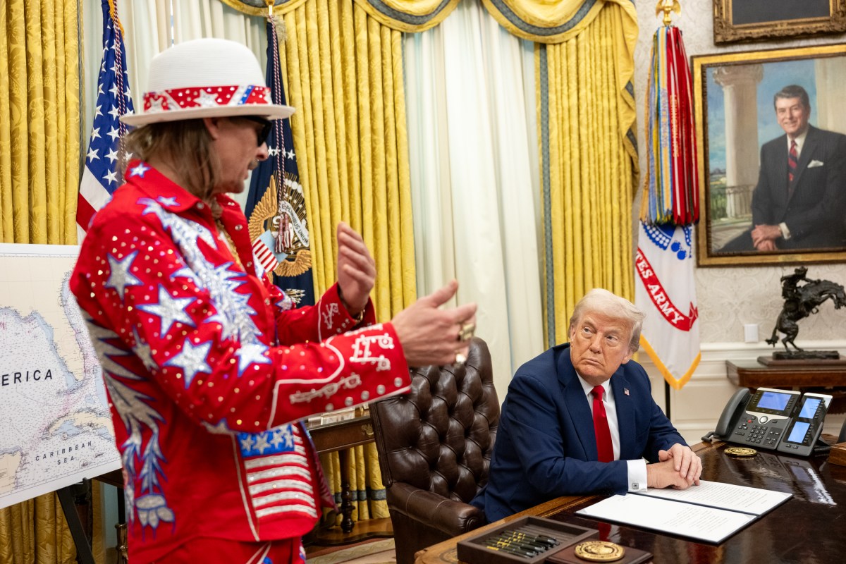 President Donald Trump signs an Executive Order alongside Kid Rock in the Oval Office, Monday, March 31, 2025. (Official White House Photo by Molly Riley)