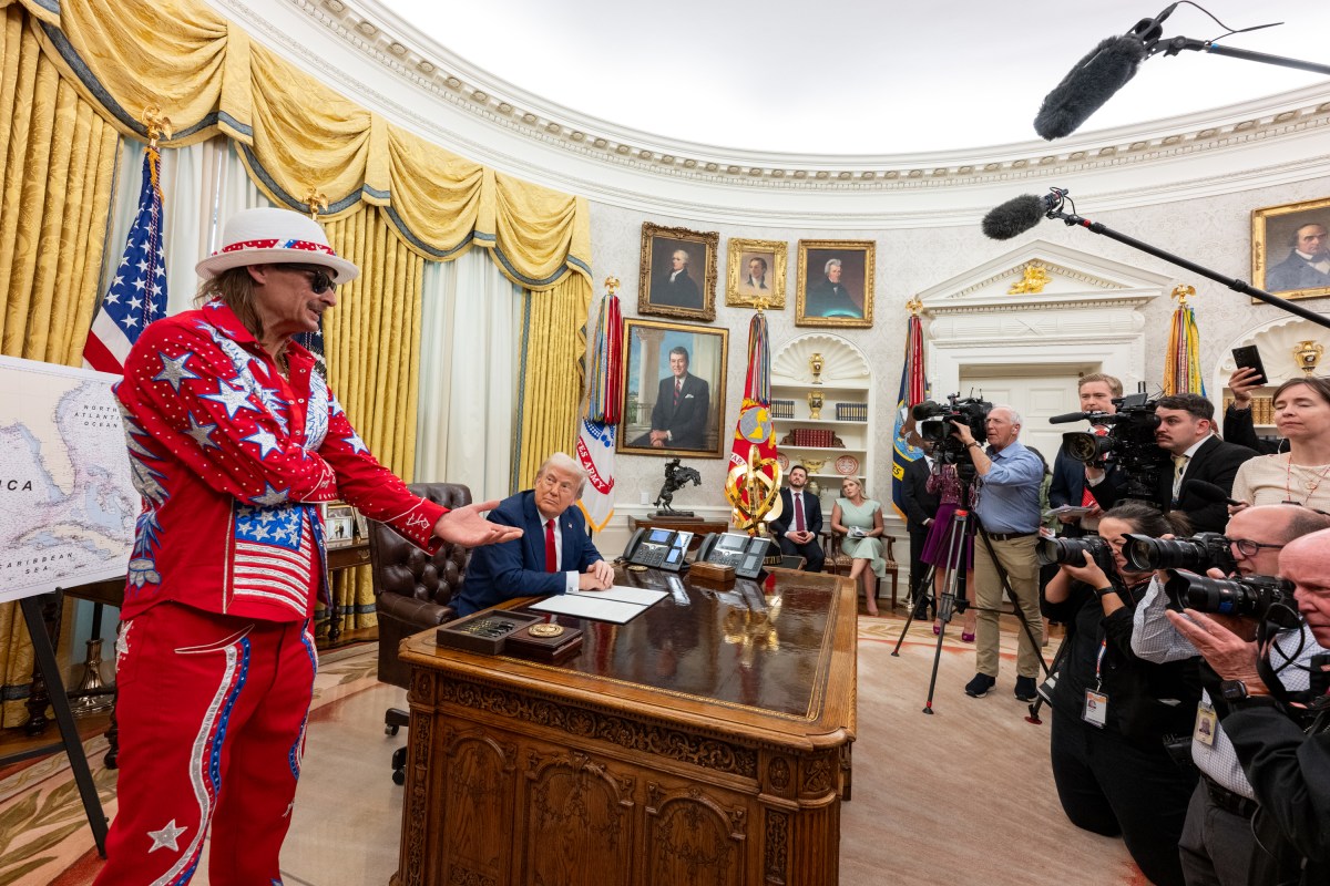 President Donald Trump signs an Executive Order alongside Kid Rock in the Oval Office, Monday, March 31, 2025. (Official White House Photo by Molly Riley)