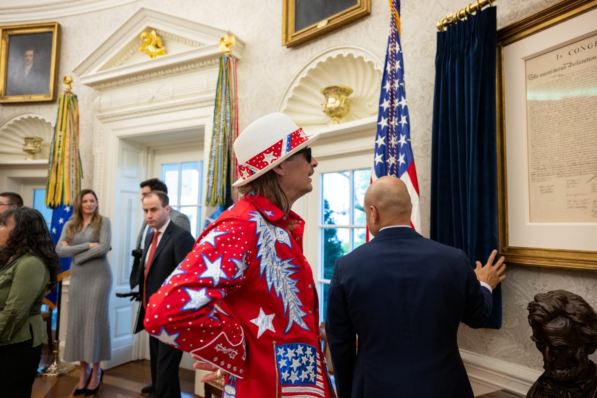 President Donald Trump signs an Executive Order alongside Kid Rock in the Oval Office, Monday, March 31, 2025. (Official White House Photo by Molly Riley)