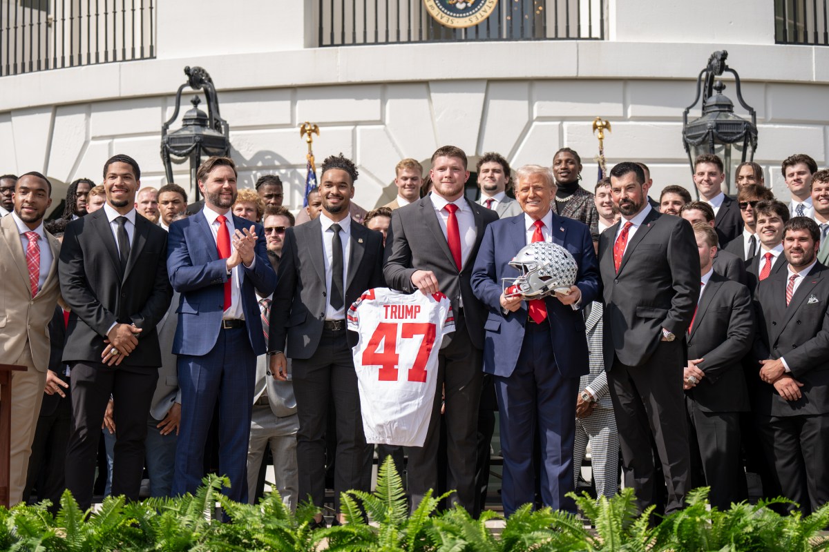 Members of the Ohio State University Buckeyes present Donald Trump with a commemorative jersey and helmet during an event celebrating the team’s 2025 College Football National Championship, Monday, April 14, 2025, at the South Portico of the White House. (Official White House Photo by Emily J. Higgins)
