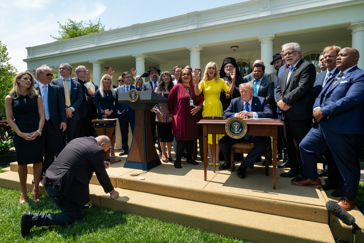 President Donald Trump prepares to sign an Executive Order alongside religious leaders at a National Day of Prayer event, Thursday, May 1, 2025, in the White House Rose Garden. (Official White House Photo by Joyce N. Boghosian)