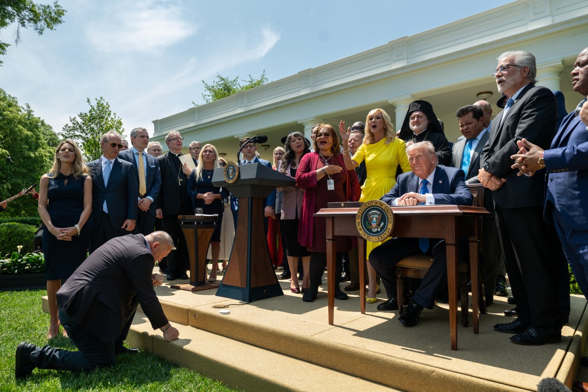 President Donald Trump prepares to sign an Executive Order alongside religious leaders at a National Day of Prayer event, Thursday, May 1, 2025, in the White House Rose Garden. (Official White House Photo by Joyce N. Boghosian)