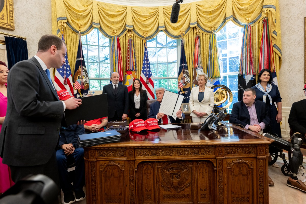 President Donald Trump signs executive orders alongside Secretary of Education Linda McMahon and wounded warriors in the Oval Office, Wednesday, April 23, 2025. (Official White House Photo by Molly Riley)
