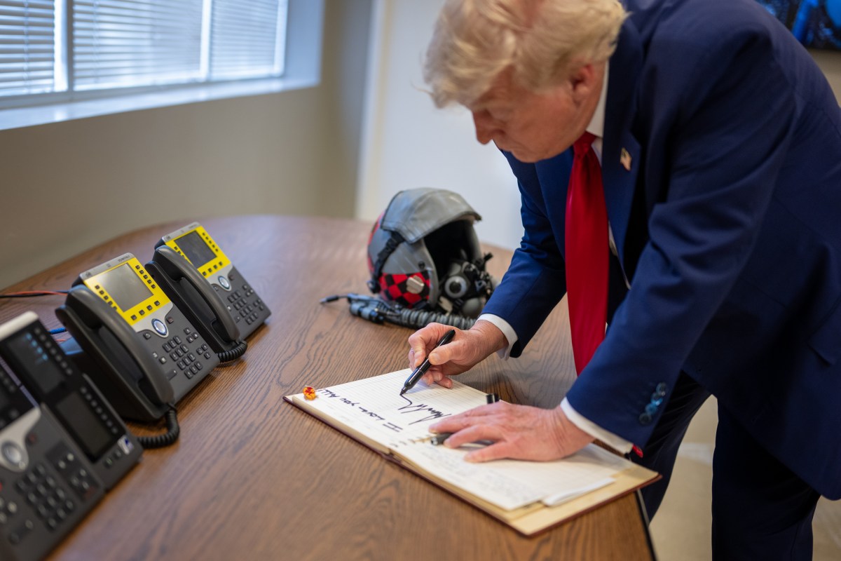 President Donald Trump signs the guestbook at Selfridge Air National Guard Base in Harrison Township, Michigan, Tuesday, April 29, 2025.(Official White House Photo by Daniel Torok)