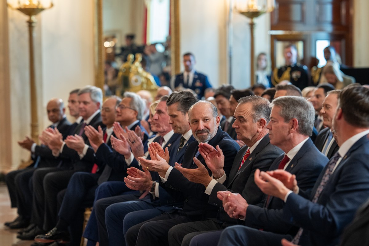 Secretary of Commerce Howard Lutnick and other members of President Donald Trump’s Cabinet clap before his remarks on “Investing in America”, Wednesday, April 30, 2025, in the Cross Hall of the White House. (Official White House Photo by Molly Riley)