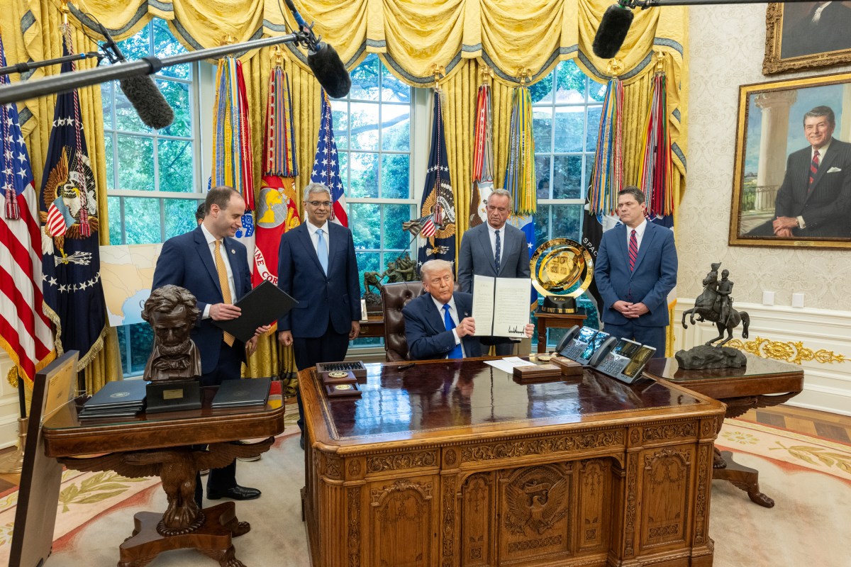 President Donald Trump signs executive orders flanked by Secretary of Health and Human Services Robert F. Kennedy, Jr. and Director of the National Institutes of Health Jay Bhattacharya, Monday, May 5, 2025, in the Oval Office. (Official White House Photo by Molly Riley)
