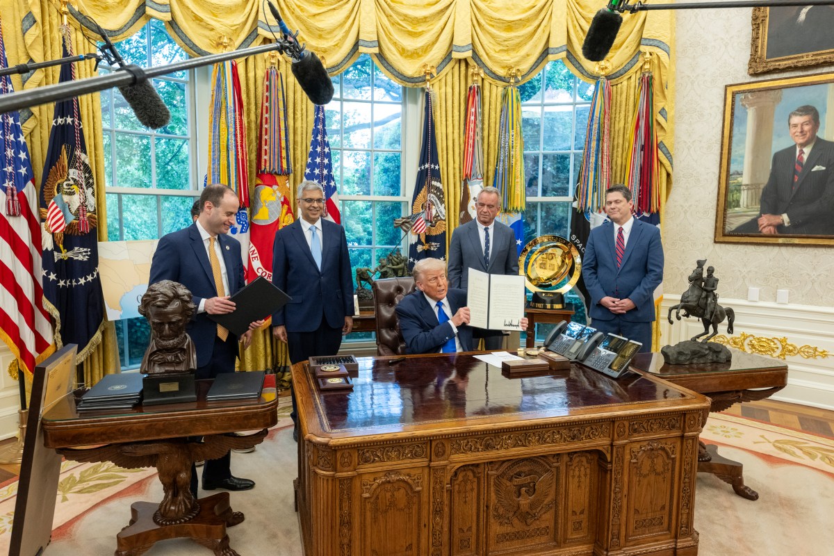 President Donald Trump signs executive orders flanked by Secretary of Health and Human Services Robert F. Kennedy, Jr. and Director of the National Institutes of Health Jay Bhattacharya, Monday, May 5, 2025, in the Oval Office. (Official White House Photo by Molly Riley)