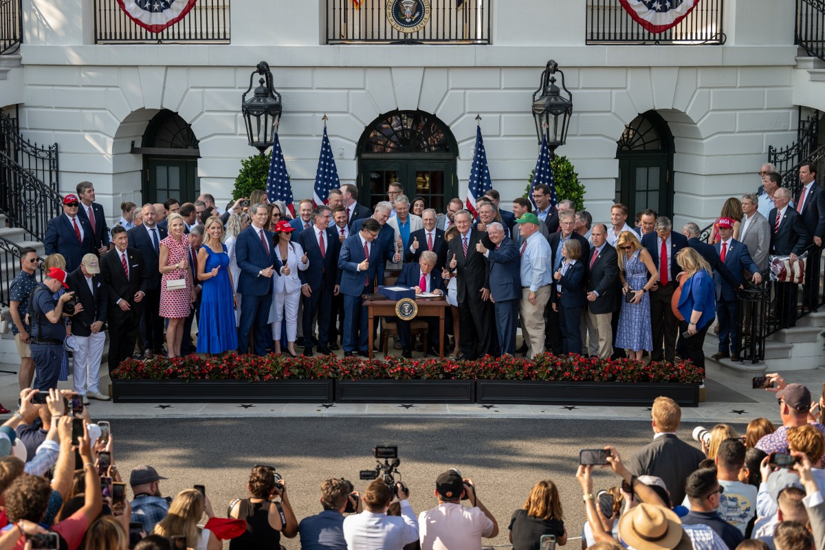 President Donald Trump signs the One Big Beautiful Bill Act on the South Lawn of the White House, Friday, July 4, 2025, during the 4th of July picnic. (Official White House Photo by Molly Riley)