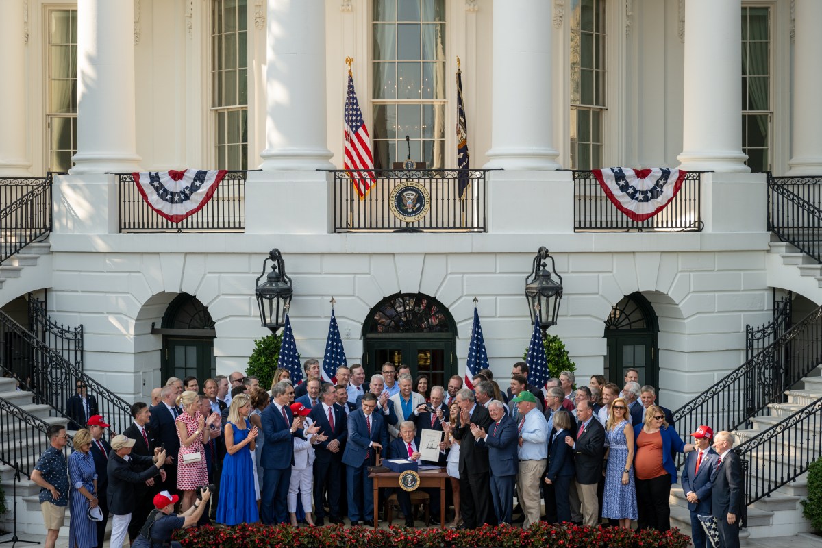 President Donald Trump signs the One Big Beautiful Bill Act on the South Lawn of the White House, Friday, July 4, 2025, during the 4th of July picnic. (Official White House Photo by Molly Riley)