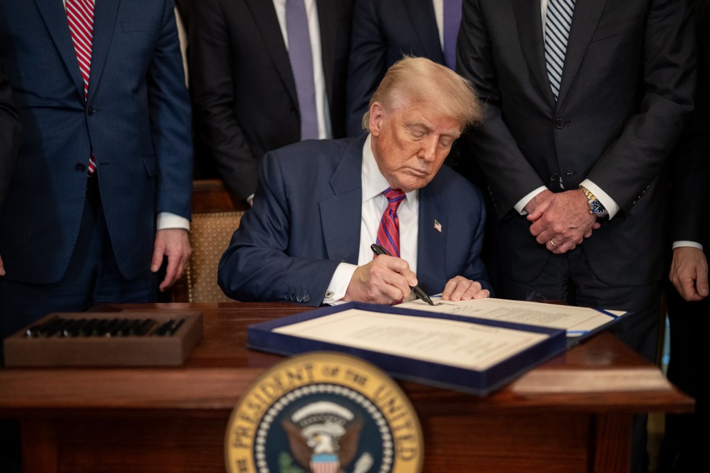 President Donald Trump signs S.1852, The GENIUS Act, Friday, July 18, 2025, in the East Room of the White House. (Official White House Photo by Daniel Torok)