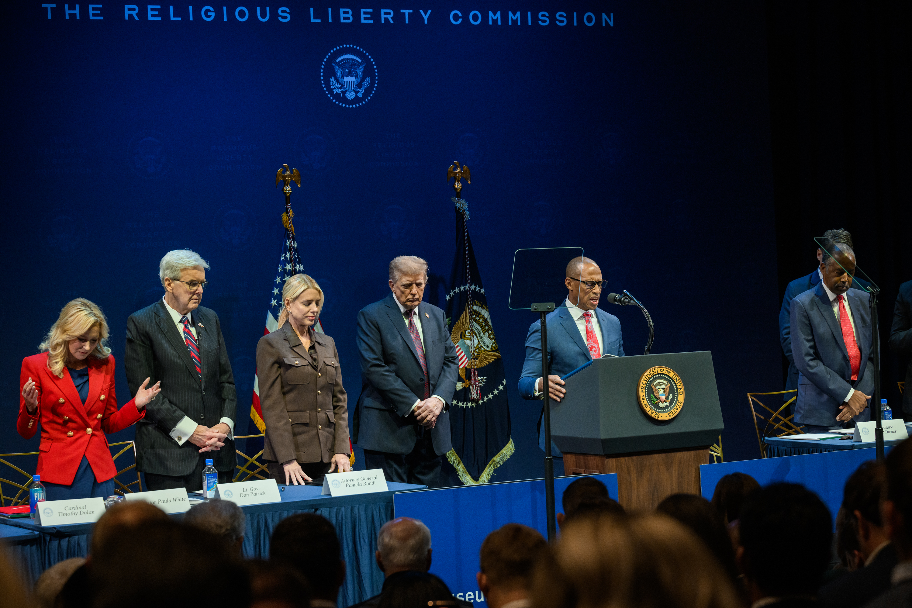 President Donald Trump looks on as Secretary of Housing and Urban Development Scott Turner delivers remarks and leads a prayer to the White House Religious Liberty Commission, Monday, September 8, 2025, at the Museum of the Bible in Washington, D.C. (Official White House Photo by Molly Riley)