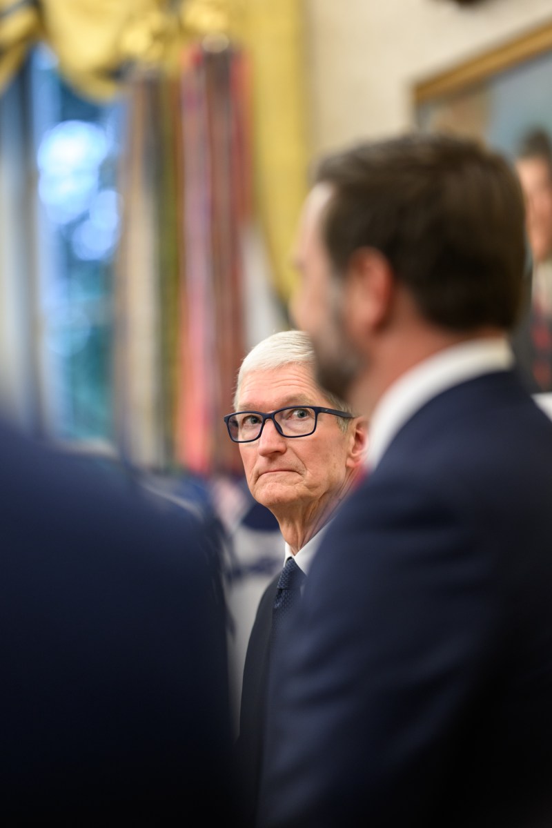 Apple CEO Tim Cook listens to Vice President JD Vance during an event announcing a $100 billion investment in the U.S., Wednesday, August 6, 2025, in the Oval Office. (Official White House Photo by Molly Riley)