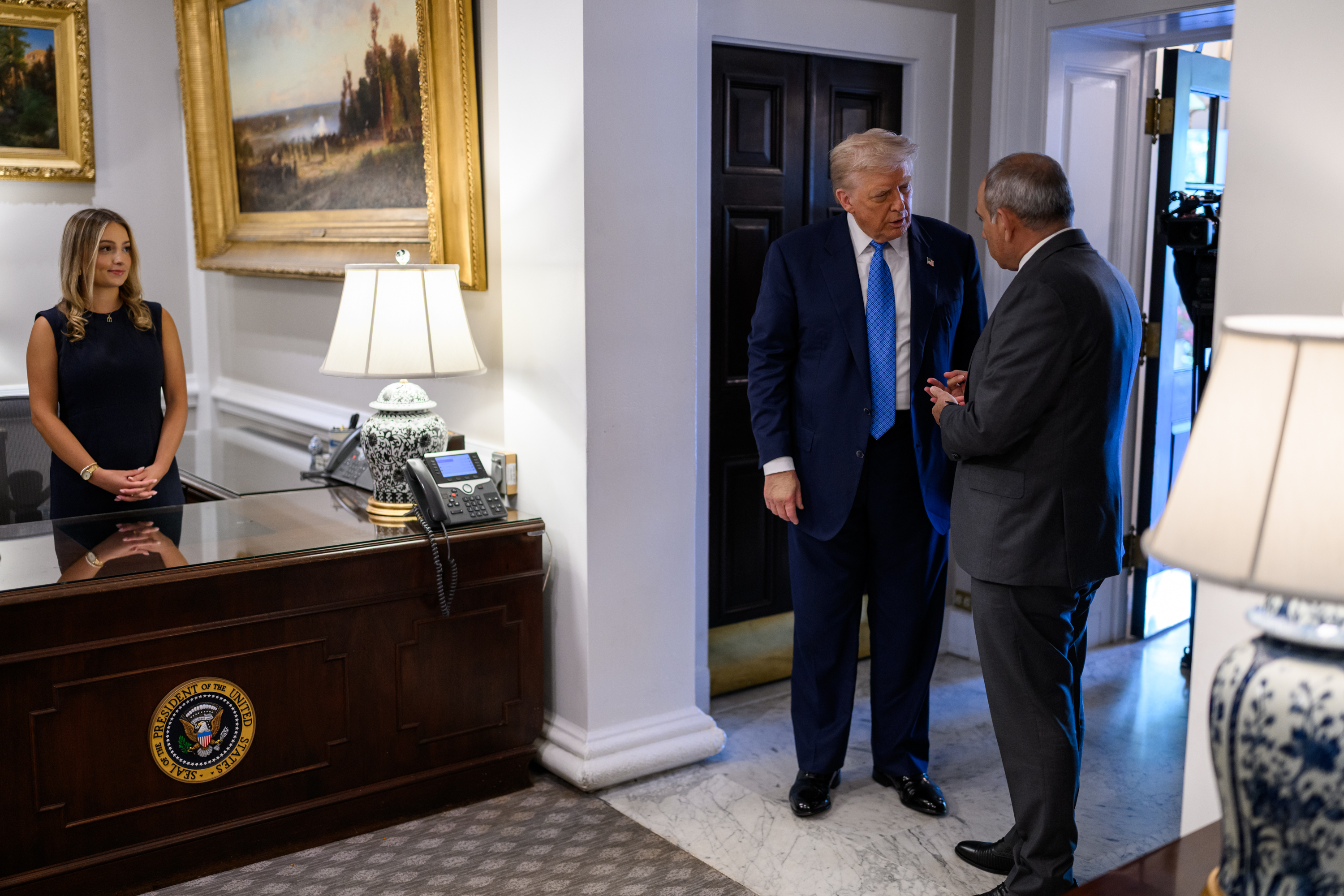 President Donald Trump signs a trilateral joint declaration with