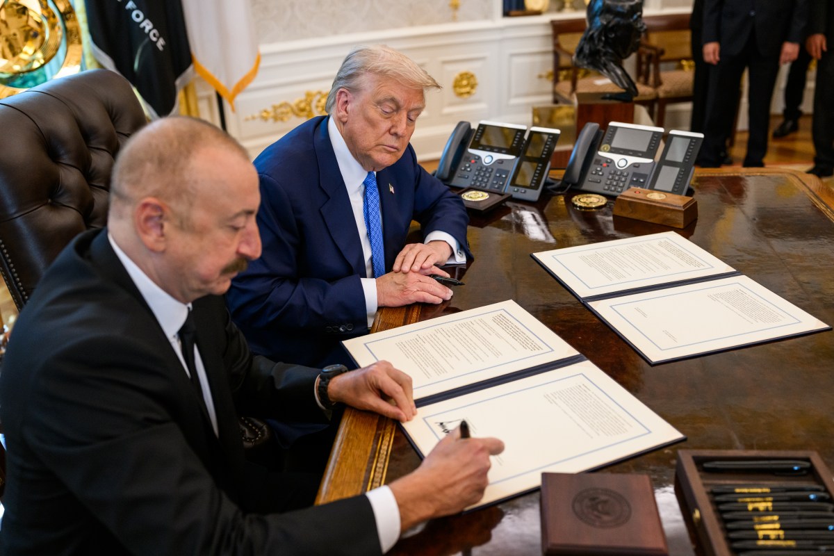 President Donald Trump signs a document alongside President Ilham Aliyev of Azerbaijan in the Oval Office, Friday, August 8, 2025. (Official White House Photo by Daniel Torok)