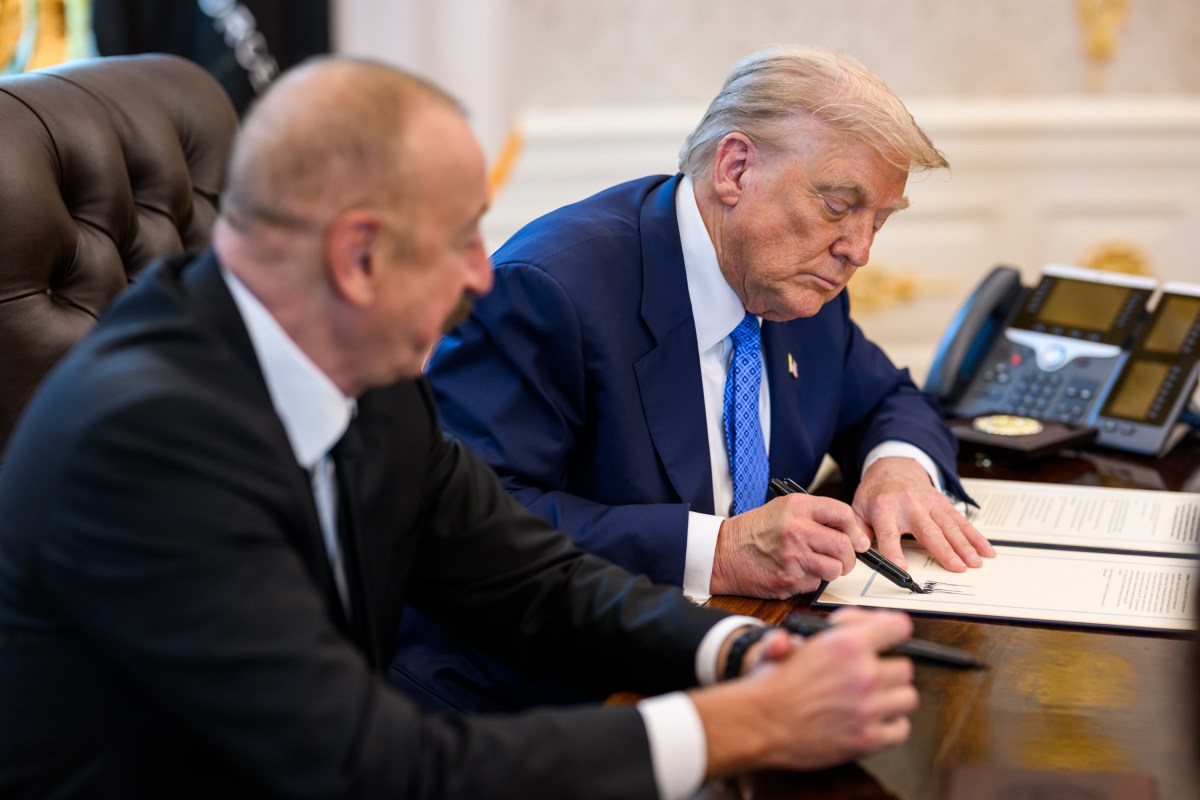 President Donald Trump signs a document alongside President Ilham Aliyev of Azerbaijan in the Oval Office, Friday, August 8, 2025. (Official White House Photo by Daniel Torok)