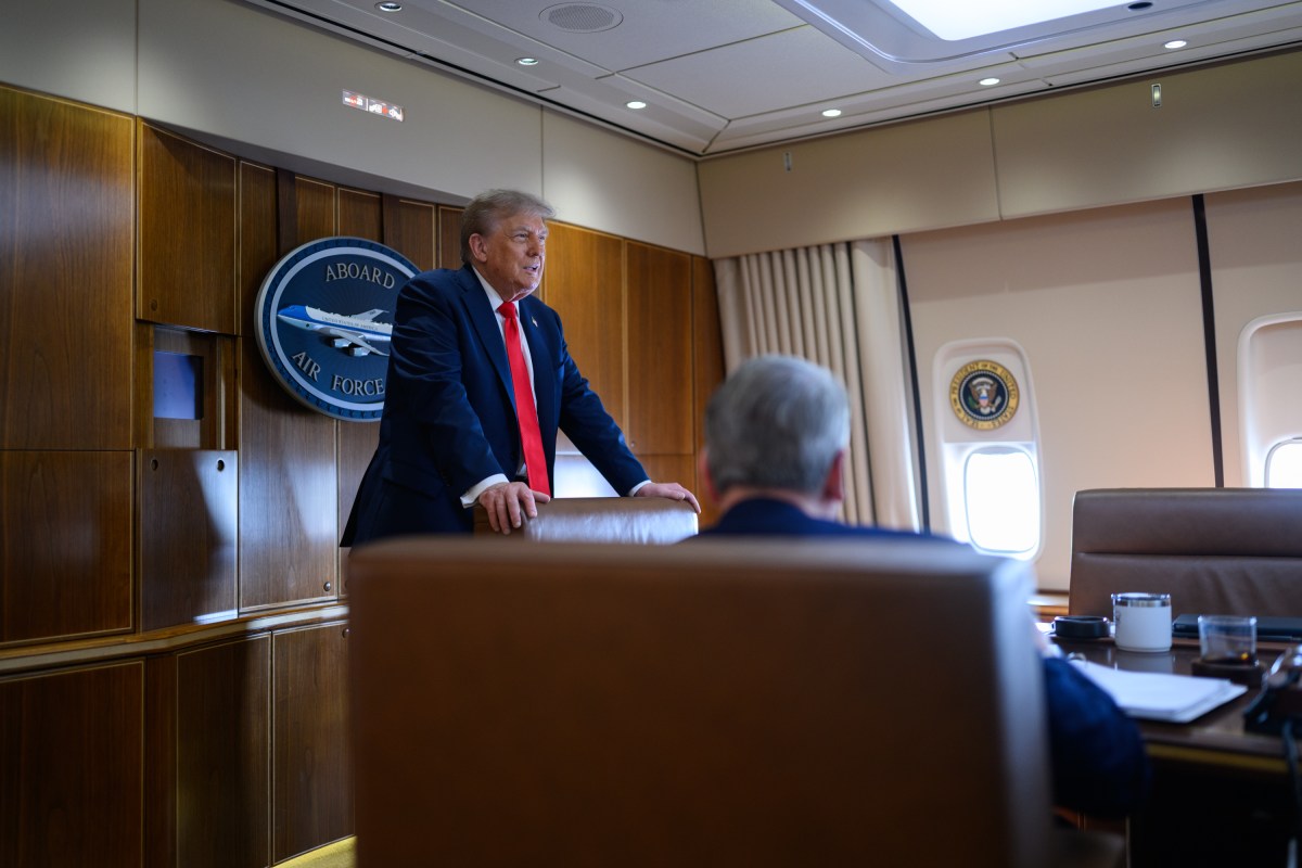 President Donald Trump speaks with staff on board Air Force One, Friday, August 15, 2025, en route to Joint Base Elmendorf Richardson, Alaska for a meeting with Russian president Vladimir Putin. (Official White House Photo by Daniel Torok)