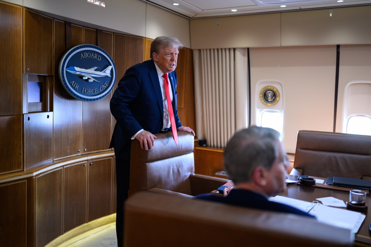 President Donald Trump speaks with staff on board Air Force One, Friday, August 15, 2025, en route to Joint Base Elmendorf Richardson, Alaska for a meeting with Russian president Vladimir Putin. (Official White House Photo by Daniel Torok)