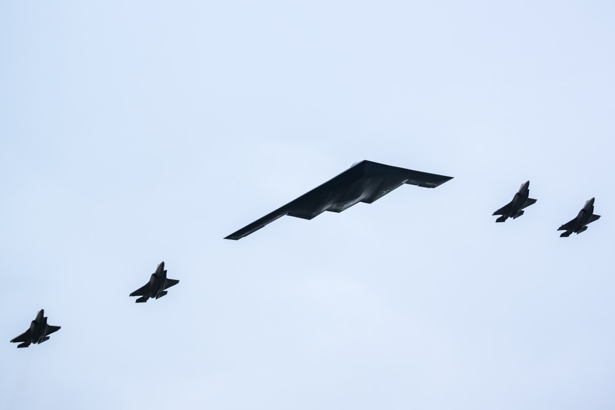 F-22 jets and a B-2 Bomber perform a flyover as President Donald Trump and Russian president Vladimir Putin meet on the tarmac at Joint Base Elmendorf Richardson in Anchorage, Alaska, Friday, August 15, 2025. (Official White House Photo by Daniel Torok)