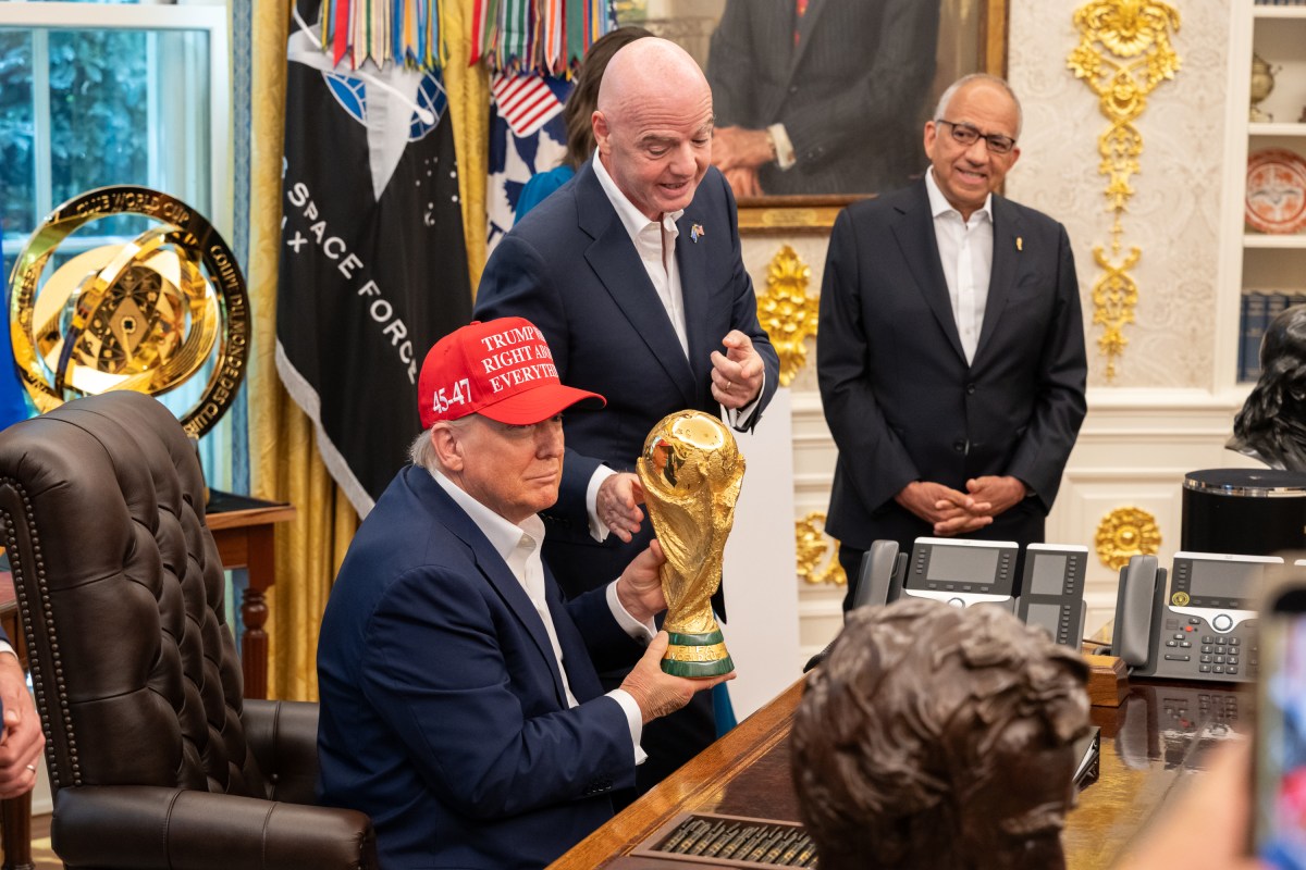 FIFA President Gianni Infantino shows President Donald Trump the FIFA World Cup Trophy during an announcement in the Oval Office, Friday, August 22, 2025. (Official White House Photo by Joyce N. Boghosian)