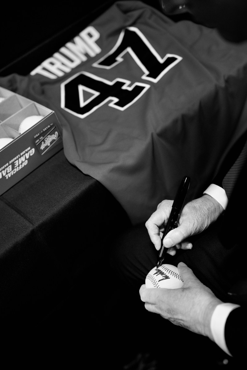 President Donald Trump signs baseballs before attending a game between the New York Yankees and Detroit Tigers on Thursday, September 11, 2025, at Yankee Stadium in the Bronx, New York. (Official White House Photo by Daniel Torok)