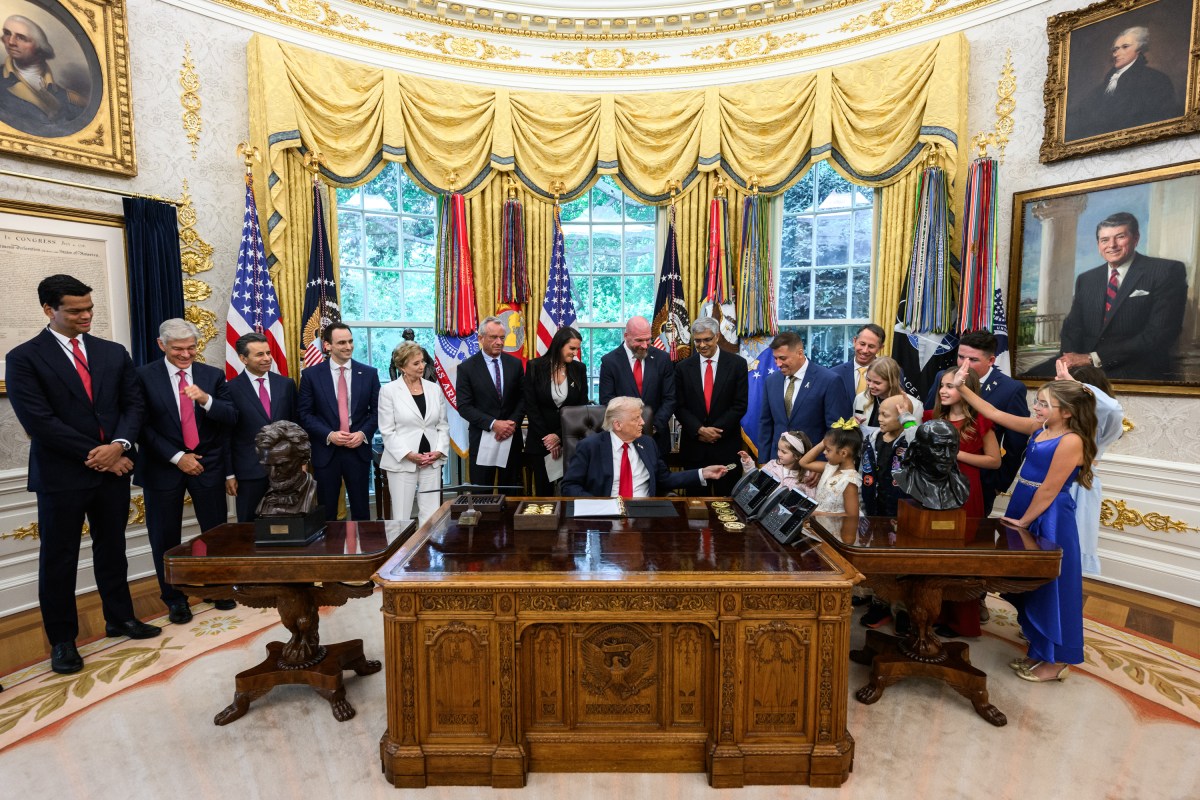 President Donald Trump, joined by HHS Secretary Robert F. Kennedy, Jr. and children affected by cancer and their families, signs an Executive Order to accelerate pediatric cancer research, Tuesday, September 30, 2025, in the Oval Office. (Official White House Photo by Molly Riley)